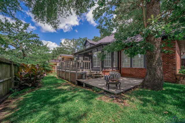 1124 Stillmeadow Ln, Longview, TX 75604 - fenced backyard featuring an outdoor fire pit, a patio area, and a sunroom