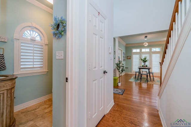 1124 Stillmeadow Ln, Longview, TX 75604 - hall featuring crown molding, plenty of natural light, stairs, and light wood-type flooring