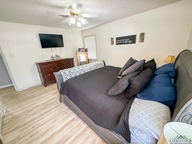 902 Warren Dr, Marshall, TX 75672 - bedroom with light wood finished floors and ceiling fan