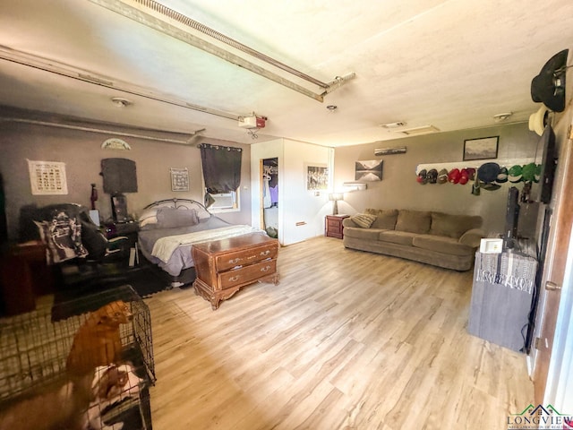 902 Warren Dr, Marshall, TX 75672 - bedroom featuring wood finished floors, a garage, and a closet