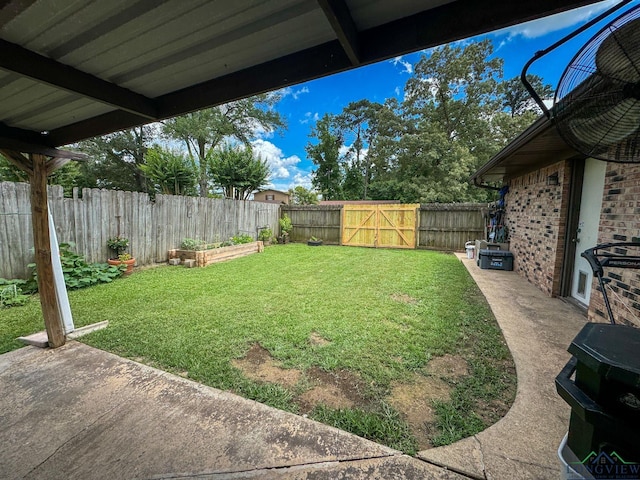 902 Warren Dr, Marshall, TX 75672 - fenced backyard featuring a patio area, a vegetable garden, and a gate