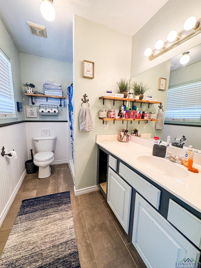 902 Warren Dr, Marshall, TX 75672 - full bathroom with vanity, a wainscoted wall, tile patterned flooring, and a shower with shower curtain