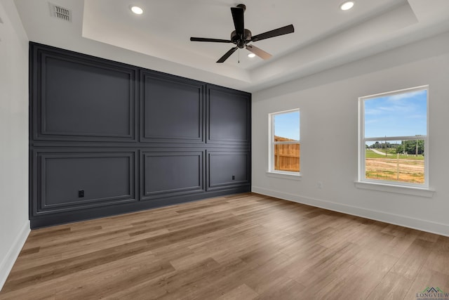 1507 Wellington Ln, Longview, TX 75605 - unfurnished bedroom with a raised ceiling, baseboards, light wood-type flooring, and recessed lighting