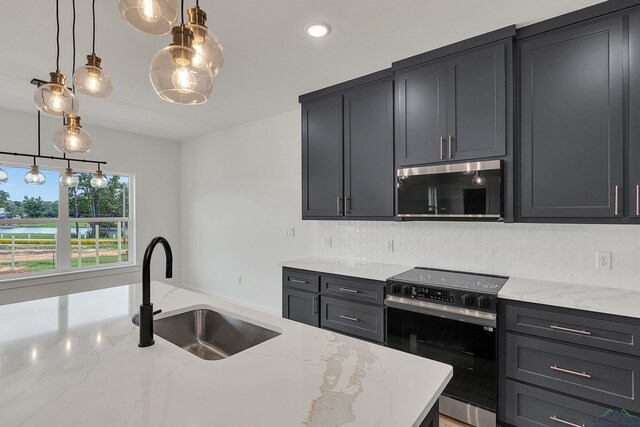 1507 Wellington Ln, Longview, TX 75605 - kitchen with stainless steel microwave, range with electric stovetop, a sink, backsplash, and recessed lighting