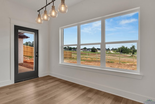 1507 Wellington Ln, Longview, TX 75605 - unfurnished dining area featuring plenty of natural light, light wood-style floors, and baseboards