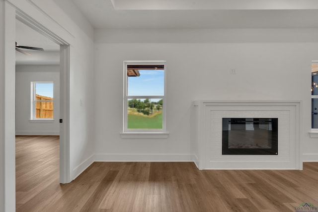 1507 Wellington Ln, Longview, TX 75605 - unfurnished living room featuring wood finished floors and plenty of natural light