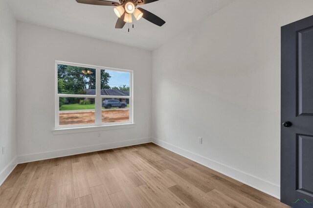 1507 Wellington Ln, Longview, TX 75605 - unfurnished room with light wood finished floors, a ceiling fan, and baseboards
