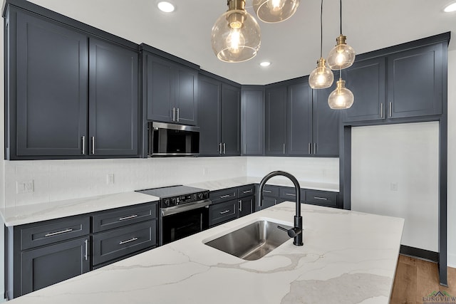 1507 Wellington Ln, Longview, TX 75605 - kitchen with stainless steel appliances, a sink, light stone countertops, decorative light fixtures, and recessed lighting