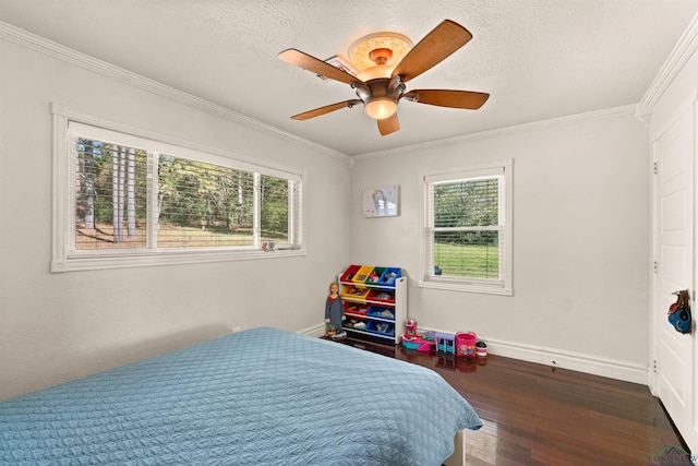 bedroom featuring multiple windows, ceiling fan, and ornamental molding