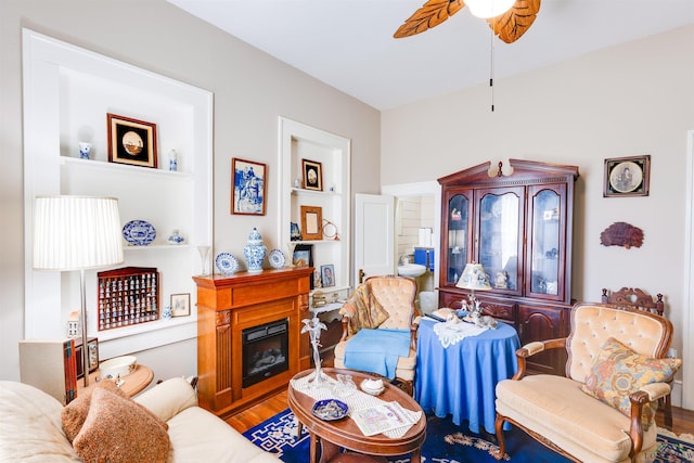 living room with ceiling fan and wood-type flooring