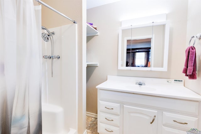 bathroom featuring vanity and curtained shower