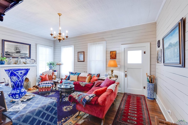 living room with a notable chandelier and dark wood-type flooring