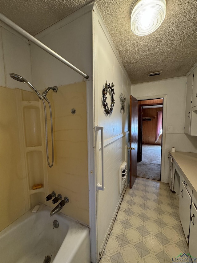 bathroom featuring vanity, shower / bath combination, and heating unit