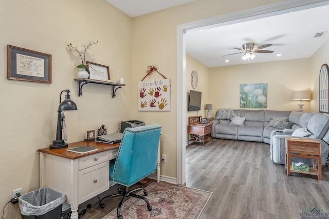 office featuring recessed lighting, visible vents, baseboards, a ceiling fan, and light wood-type flooring