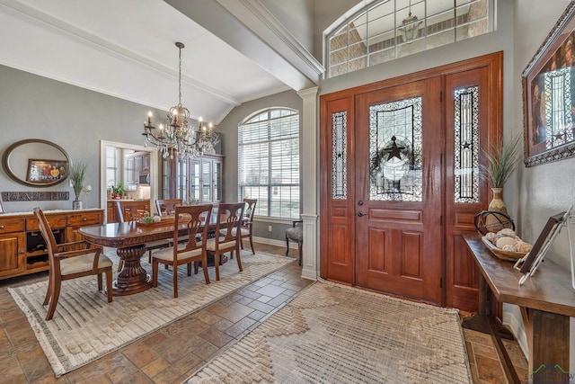 entrance foyer featuring a chandelier, high vaulted ceiling, stone tile floors, baseboards, and beamed ceiling