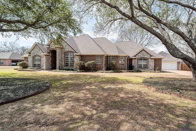 french country inspired facade with a front lawn