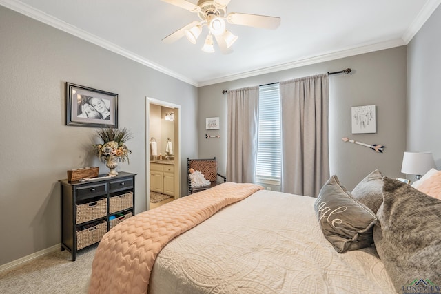 bedroom with crown molding, light colored carpet, ensuite bathroom, a ceiling fan, and baseboards