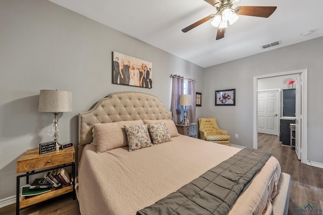 bedroom featuring ceiling fan, wood finished floors, visible vents, and baseboards