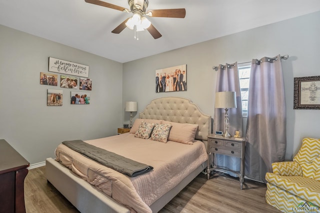 bedroom featuring baseboards, a ceiling fan, and wood finished floors