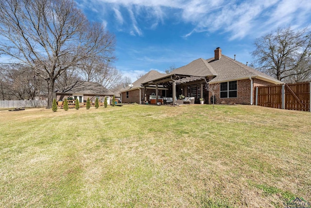 rear view of property with a chimney, fence, a yard, a pergola, and brick siding