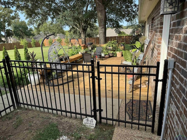 view of gate featuring a fenced backyard