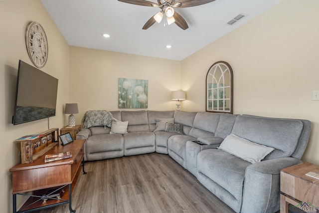 living area with ceiling fan, wood finished floors, visible vents, and recessed lighting