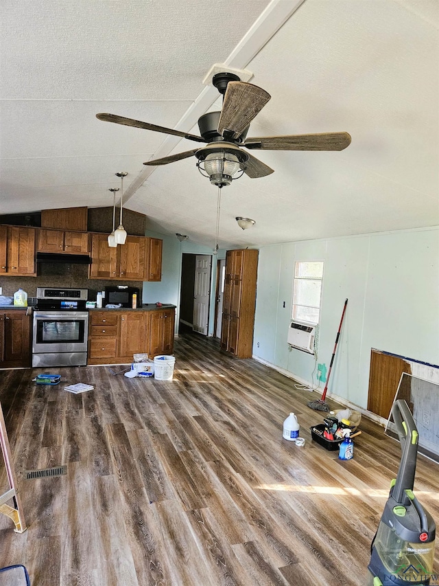 kitchen with hanging light fixtures, vaulted ceiling, ceiling fan, dark hardwood / wood-style floors, and stainless steel range oven