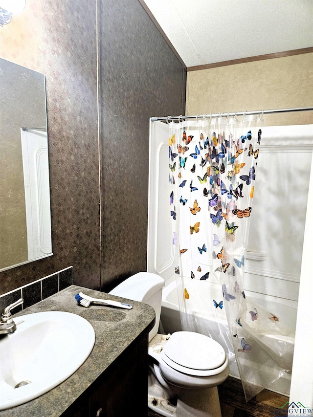 full bathroom featuring vanity, toilet, ornamental molding, a textured ceiling, and shower / tub combo