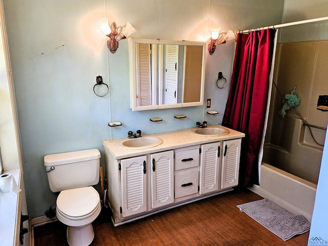 full bathroom featuring hardwood / wood-style floors, vanity, toilet, and shower / bathtub combination with curtain