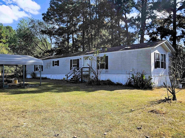 manufactured / mobile home with a front yard and a carport