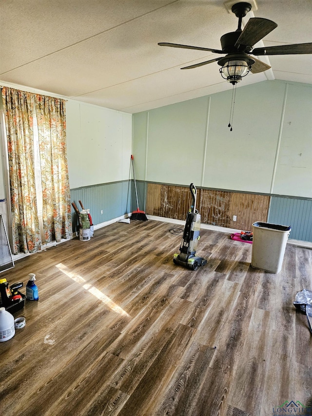 interior space with vaulted ceiling, ceiling fan, wood-type flooring, and a textured ceiling