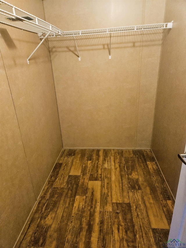 walk in closet featuring dark wood-type flooring