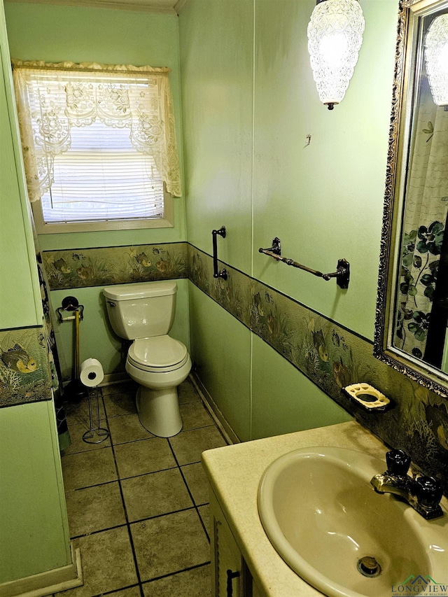 bathroom featuring tile patterned flooring, vanity, and toilet