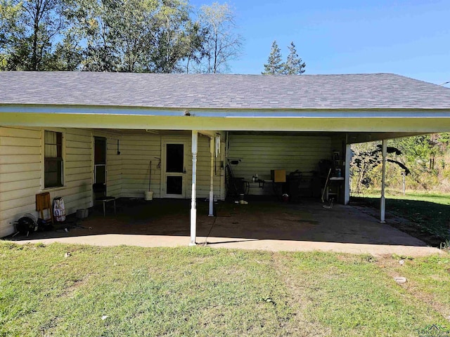 view of parking with a carport and a lawn