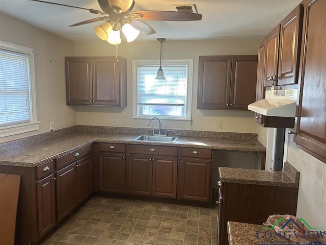 kitchen with ceiling fan, sink, pendant lighting, and dark brown cabinetry