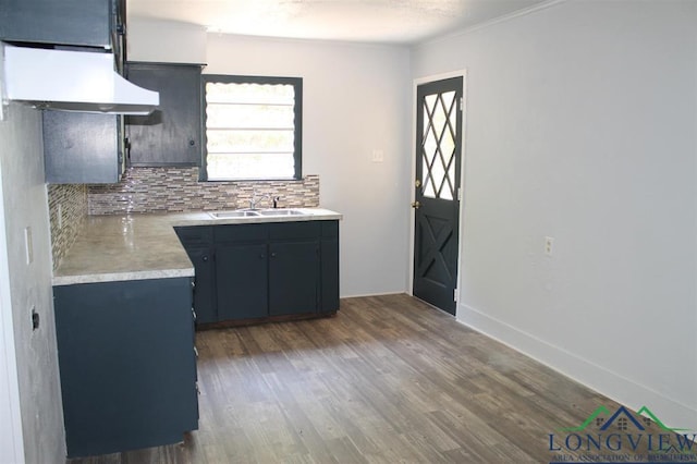 kitchen with dark hardwood / wood-style floors, crown molding, sink, and tasteful backsplash