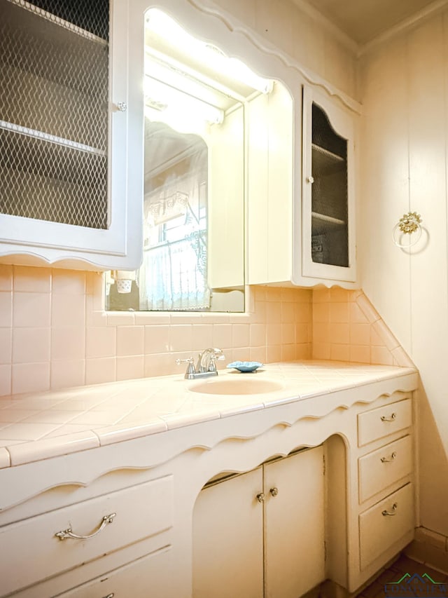 bathroom with decorative backsplash and vanity