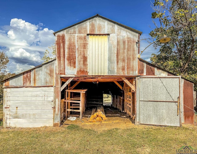 view of outbuilding featuring a lawn