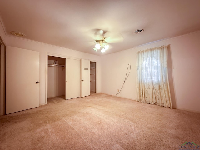 unfurnished bedroom featuring ceiling fan, carpet floors, and ornamental molding