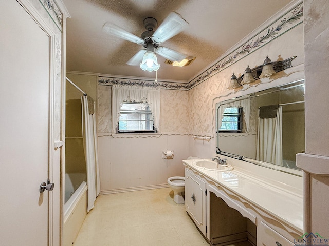 full bathroom featuring shower / bath combo with shower curtain, vanity, a healthy amount of sunlight, and toilet