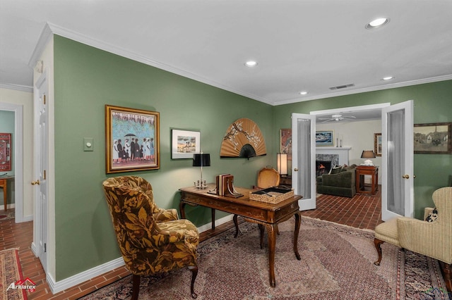 office area with ceiling fan and crown molding