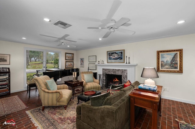 living room with crown molding and a premium fireplace