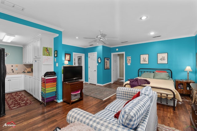 bedroom featuring ceiling fan, crown molding, and dark wood-type flooring