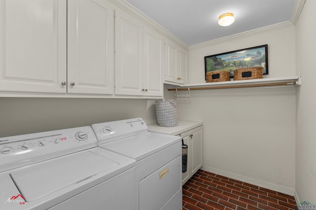 laundry area with washer and dryer, cabinets, and crown molding