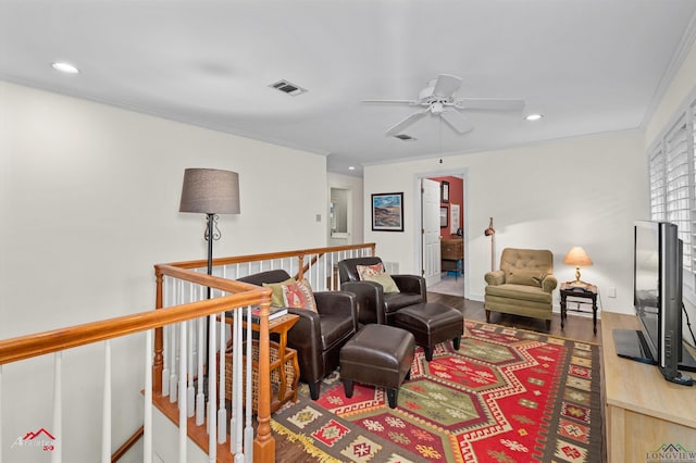 living room with crown molding, ceiling fan, and hardwood / wood-style flooring