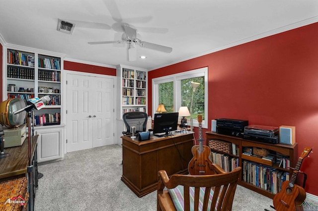 office with built in shelves, ceiling fan, light colored carpet, and ornamental molding