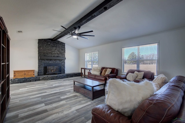 living room with hardwood / wood-style flooring, a stone fireplace, a healthy amount of sunlight, and ceiling fan