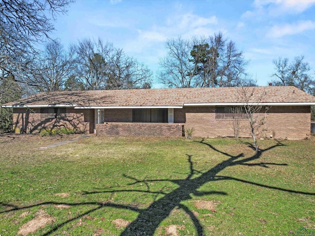 exterior space featuring a lawn and brick siding