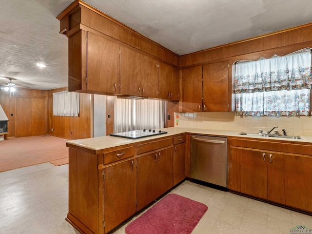 kitchen featuring a sink, brown cabinetry, light countertops, and dishwasher