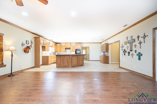 unfurnished living room with ceiling fan, light hardwood / wood-style flooring, and ornamental molding